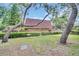 Green backyard with lawn and landscaping at 714 1St Ct, Palm Harbor, FL 34684