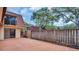 Private backyard with stained concrete and wood fence at 714 1St Ct, Palm Harbor, FL 34684