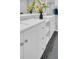 Bright bathroom with white cabinets and gray tile floors at 714 1St Ct, Palm Harbor, FL 34684