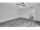 Bright bedroom features a ceiling fan and neutral paint, ready for your personal touch at 714 1St Ct, Palm Harbor, FL 34684