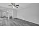 A simple bedroom leads to bathroom and has a ceiling fan, closet with mirrored sliding doors at 714 1St Ct, Palm Harbor, FL 34684
