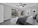 Modern bedroom with balcony access boasts natural light and sliding mirror closet doors at 714 1St Ct, Palm Harbor, FL 34684