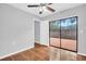 A bright bedroom features wood look tiles and access to an outdoor patio at 714 1St Ct, Palm Harbor, FL 34684