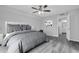 Comfortable bedroom with gray color scheme, modern decor, and an ensuite bathroom at 714 1St Ct, Palm Harbor, FL 34684