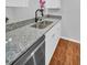 The kitchen features granite countertops and stainless steel sink at 714 1St Ct, Palm Harbor, FL 34684
