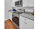 The kitchen features granite countertops and stainless steel appliances at 714 1St Ct, Palm Harbor, FL 34684