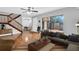 Bright living room with tile floors, large sliding glass doors, and staircase at 714 1St Ct, Palm Harbor, FL 34684