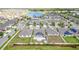 Beautiful aerial view of a neighborhood with a lake and many houses at 7305 Tiger Trail Ct, Sun City Center, FL 33573