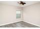 Bedroom with gray vinyl flooring and ceiling fan; natural light through the window at 7305 Tiger Trail Ct, Sun City Center, FL 33573