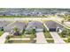 Beautiful single-story home featuring a well-manicured lawn, palm trees, and solar panels at 7305 Tiger Trail Ct, Sun City Center, FL 33573