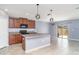 Modern kitchen featuring an island with granite countertops and modern pendant lights at 7305 Tiger Trail Ct, Sun City Center, FL 33573
