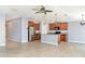 Open-concept kitchen with stainless steel appliances, island and modern lighting at 7305 Tiger Trail Ct, Sun City Center, FL 33573