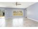 Bright living room featuring tile floors, ceiling fan, and sliding glass doors at 7305 Tiger Trail Ct, Sun City Center, FL 33573