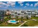 Elevated angle showcasing condo buildings, a pristine pool, and lush landscaping at 7872 Sailboat Key S Blvd # 301, South Pasadena, FL 33707