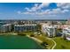 Beautiful aerial view of a waterfront condo community featuring lush landscaping and a swimming pool at 7872 Sailboat Key S Blvd # 301, South Pasadena, FL 33707