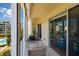 Balcony view showcases a patio table, and views of the pool and nearby condos at 7872 Sailboat Key S Blvd # 301, South Pasadena, FL 33707