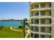 Charming condo balcony overlooking a lush lawn, calm water and a stunning waterfront view at 7872 Sailboat Key S Blvd # 301, South Pasadena, FL 33707
