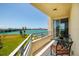 Balcony with table and chairs, offering views of the bay and vibrant green space at 7872 Sailboat Key S Blvd # 301, South Pasadena, FL 33707