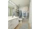 Bright bathroom with a marble countertop, vanity with drawers and cabinet, plus artwork and a shower curtain at 7872 Sailboat Key S Blvd # 301, South Pasadena, FL 33707