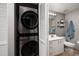 Modern bathroom adjacent to a closet with stacked washer and dryer for added convenience at 7872 Sailboat Key S Blvd # 301, South Pasadena, FL 33707