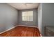 Minimalist bedroom with hardwood floors, neutral walls, white trim, a ceiling fan and a large window at 7872 Sailboat Key S Blvd # 301, South Pasadena, FL 33707