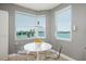Bright breakfast nook with water views and clear acrylic chairs at 7872 Sailboat Key S Blvd # 301, South Pasadena, FL 33707