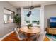 Dining area featuring modern pendant lighting, a wood table, and views of the waterway at 7872 Sailboat Key S Blvd # 301, South Pasadena, FL 33707