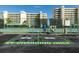 EV charging station in front of tennis courts. Buildings and green spaces visible in the background at 7872 Sailboat Key S Blvd # 301, South Pasadena, FL 33707