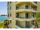 Exterior view of the condominium showing private balconies overlooking the bay at 7872 Sailboat Key S Blvd # 301, South Pasadena, FL 33707