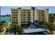 Beautiful waterfront condo building with covered parking, lush landscaping, and stunning views at 7872 Sailboat Key S Blvd # 301, South Pasadena, FL 33707