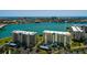 A scenic view of waterfront condos overlooking tranquil blue waters and city in the distance at 7872 Sailboat Key S Blvd # 301, South Pasadena, FL 33707