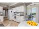 Well-equipped kitchen with white cabinets, granite counters, and access to outdoor balcony at 7872 Sailboat Key S Blvd # 301, South Pasadena, FL 33707