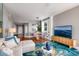 Living room with hardwood floors, comfortable seating, and access to dining and hallway at 7872 Sailboat Key S Blvd # 301, South Pasadena, FL 33707
