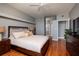 Spacious main bedroom with stylish decor, hardwood floors, and a glimpse of the en suite bath at 7872 Sailboat Key S Blvd # 301, South Pasadena, FL 33707