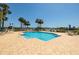 Relaxing pool area featuring inviting blue waters, lounge chairs, and serene palm trees at 7872 Sailboat Key S Blvd # 301, South Pasadena, FL 33707
