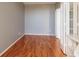 A bright room with hardwood floors, neutral walls, and glass-paned doors to an adjacent room at 7872 Sailboat Key S Blvd # 301, South Pasadena, FL 33707