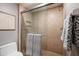 Tiled shower features a sleek glass door and convenient built-in shelves, complemented by neutral-colored walls at 7872 Sailboat Key S Blvd # 301, South Pasadena, FL 33707