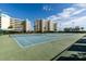 Well-maintained tennis courts with green and blue surfaces, surrounded by trees and residential buildings at 7872 Sailboat Key S Blvd # 301, South Pasadena, FL 33707