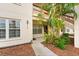 Entrance to unit with well manicured landscaping, exterior lights, and view of parking area at 7910 Hardwick Dr # 717, New Port Richey, FL 34653