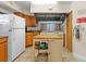 The communal kitchen is equipped with a stovetop, stainless steel hood, and refrigerator at 7910 Hardwick Dr # 717, New Port Richey, FL 34653