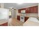 Well-lit kitchen featuring dark wood cabinets, modern appliances, and ample counter space at 7910 Hardwick Dr # 717, New Port Richey, FL 34653