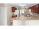 Well-lit kitchen featuring dark wood cabinets, modern appliances, and outdoor access at 7910 Hardwick Dr # 717, New Port Richey, FL 34653