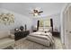 Stylish bedroom featuring a cozy bed, elegant furniture, ceiling fan, and a bright window with outdoor views at 7910 Hardwick Dr # 717, New Port Richey, FL 34653