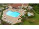 Aerial view of community pool, patio and lounge area with tables and chairs at 7910 Hardwick Dr # 717, New Port Richey, FL 34653