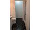 A half bathroom with black tile floors and shower access at 8114 Oak Trace Way # D, Tampa, FL 33634