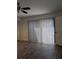 This bedroom features hardwood floors, a ceiling fan, and sliding glass doors at 8114 Oak Trace Way # D, Tampa, FL 33634