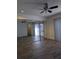 Spacious bedroom with hardwood floors, ceiling fan, and mirrored closet at 8114 Oak Trace Way # D, Tampa, FL 33634