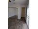 Bedroom featuring a mirrored closet and wood style flooring and a door that leads to other rooms at 8114 Oak Trace Way # D, Tampa, FL 33634