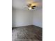 Bedroom featuring a ceiling fan and wood-style flooring, perfect for relaxation and comfort at 8114 Oak Trace Way # D, Tampa, FL 33634
