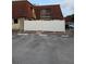 Townhouse with a white fence, red brick walk way, dark windows and parking spaces at 8114 Oak Trace Way # D, Tampa, FL 33634